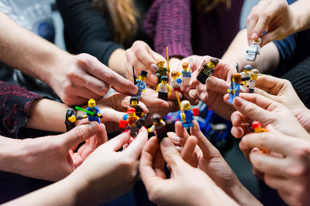 Many lego people being pushed together