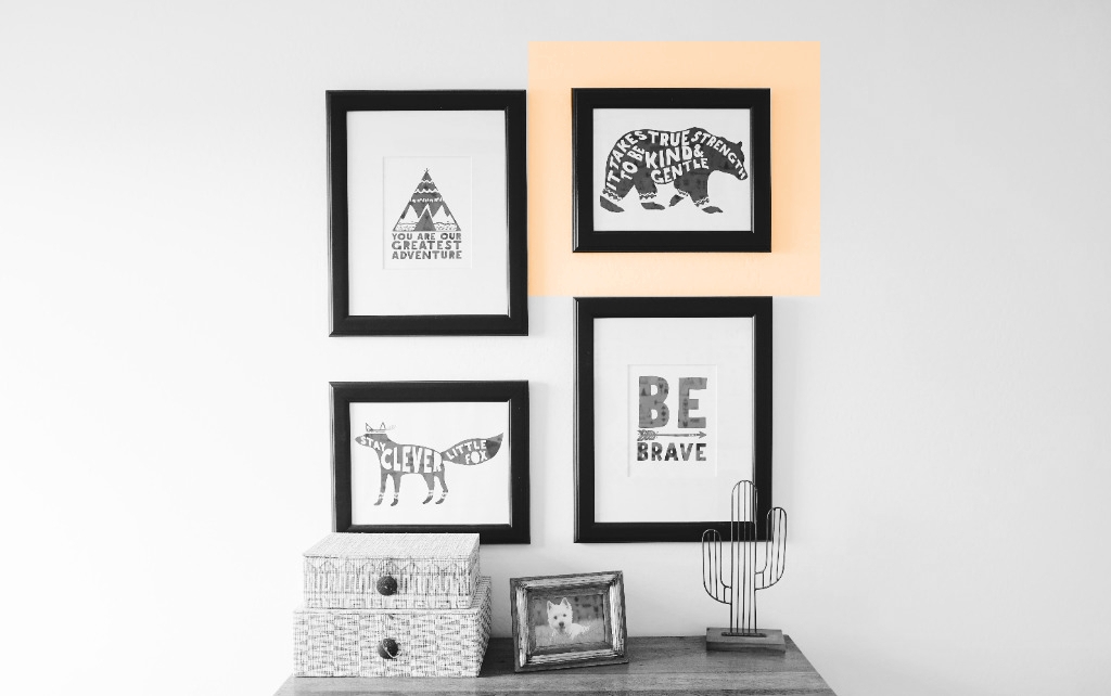 pictures hanging on a wall. one has the area of wall surrounding it highlighted