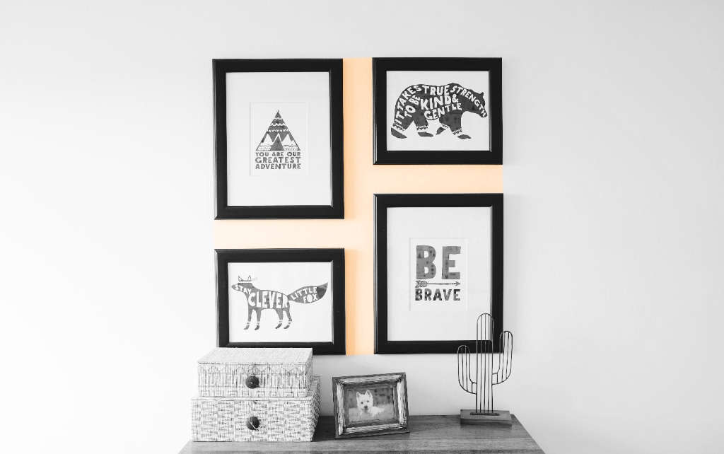 pictures hanging on a wall. the distance between them is highlighted