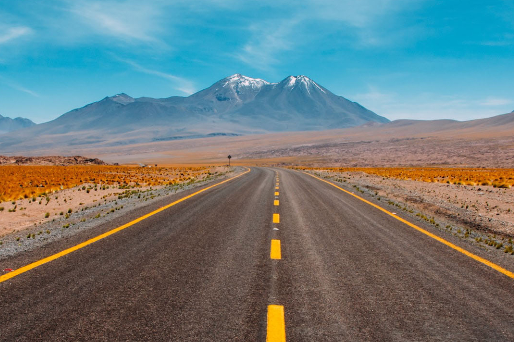 A wider road than the last, in the desert