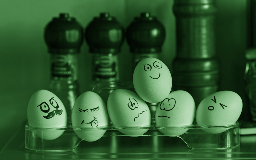 A bunch of eggs, each with a cartoon face displaying a common emotion. Eg: happy, sad, etc.