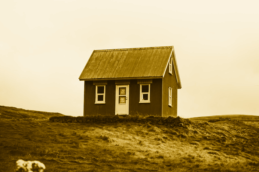 A small house on top of a hill