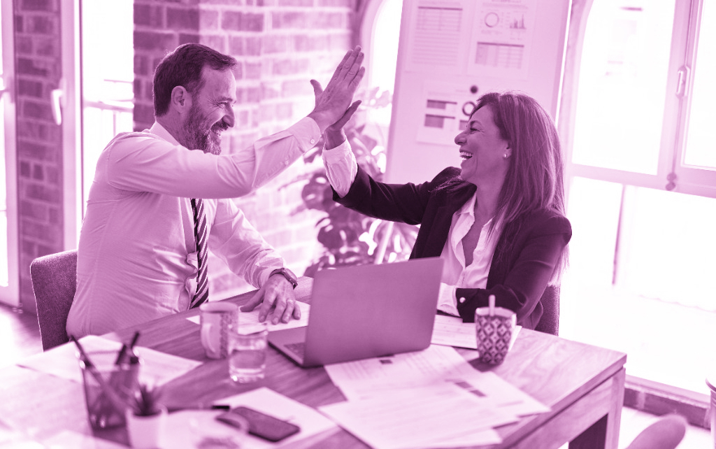 A corporate dressed team high fiving